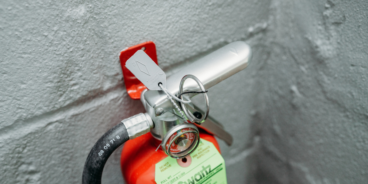 Close up of a fire extinguisher and its pin